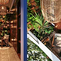 Villa Balcony With Lush Green Plants Wicker Pendant Light Wooden Ceiling And Outdoor Seating