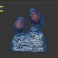 Red Bird Figurines Perched On White Base With Green Moss