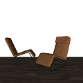 Modern Brown Leather Lounge Chair With Black Metal Frame On Wooden Floor