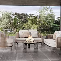Outdoor Sofa Set With Fire Pit Coffee Table And Green Plants On Patio