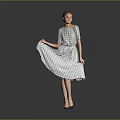 Woman Lifting Patterned Dress Standing With High Heels On Gray Background