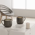 Steaming Black Mugs On White Table With Lit Candle In Bright Modern Room Setting