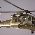 Military Helicopter Taking Off From Dusty Ground With Rotors Spinning