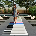 Park Landscape With Piano Keyboard Path Colorful Lights People Walking Round Lights And Pool Area