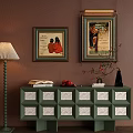 Green Console Cabinet with White Decorative Drawers Wall Art Floor Lamp Vase and Books