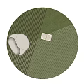 Green Striped Round Rug With White Cushion And Open Book