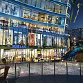 Modern Sky Mall Night Scenery With Glass Facade Bright Lights Slide And Plaza Near High Rise Buildings