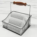 White Towels Neatly Stored in Metal Basket With Wooden Handle on Marble Countertop