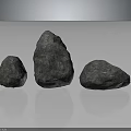 Three Gray Natural Stones with Rough Surfaces and Various Shapes on Reflective Base