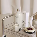 Modern Rolling Storage Rack with Toiletries Bottles Mirror and Towel on Bathroom Countertop