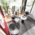 Modern Window Display with Red Wall Hanging Green Vines Cacti Gray Armchairs and Round Table