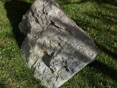 Large Gray Rock With Rough Surface And Cracks On Green Grass Field 3d model