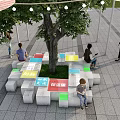 Tree Pit With Colorful Seating Blocks And Illuminated Design In Urban Square