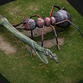 Large Reptile Sculpture Display With Insect Figures On Green Grass Area