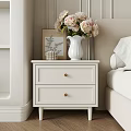 Two Drawer White Chest Of Drawers In Modern Bedroom With Vase Flowers And Artwork