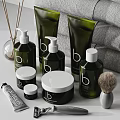 Modern Bathroom Accessories With Green Toiletries Stacked Gray Towels Shaving Brush And Reed Diffuser