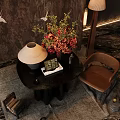 Elegant Black Round Console Table With Floral Arrangement Crane Patterned Backdrop And Table Lamp
