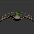Futuristic Metallic Accessory With Silver Gold Finish Central Green Gemstone And Streamlined Wing Like Structures