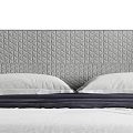Modern Upholstered Double Bed with Quilted Gray Headboard White Pillows and Wooden Legs
