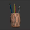 Copper Pen Holder With Colored Pencils On Dark Reflective Surface