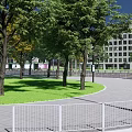 Traffic Signage At Urban Intersection With Zebra Crossings Vehicles And Street Lamps