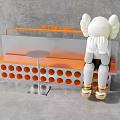 Stylish Public Bench with Orange Round Holes Silver Table and White Doll with Gold Shoes