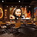 Cozy Modern Bar Interior With Warm Lighting Wooden Tables Green Plants And Circular Decor