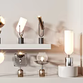 Modern Table Lamps With Various Designs And Metal Bases On Display Shelves