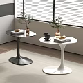 Black and White Round Side Tables with Curved Base Potted Plants Coffee Mug and Books