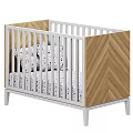 Modern Baby Crib With White Railings Wooden Herringbone Panel And Polka Dot Bedding