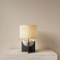 Modern Minimalist Table Lamp With Beige Lampshade And Black Square Base With White Semicircle