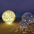 Spherical Outdoor Lights With Woven Design And Hollow Dots Projecting Light Spots On Beach