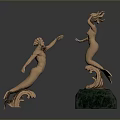 Two Golden Mermaid Sculptures With Intricate Details And Green Base Decoration