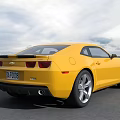 Yellow Chevrolet Camaro Sports Car With Sleek Design On Road Surface