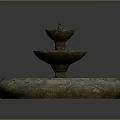 Three Tiered Stone Fountain With Weathered Surface And Round Base