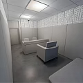 Minimalist Lounge Area Interior With White Table Chairs Blue Wall And Perforated Panels