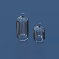 Two Transparent Glass Striped Bottles With Lids On Blue Background