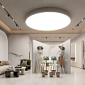 Modern Clothing Store Interior With Mannequins Sofa Potted Plants And Clothes Racks