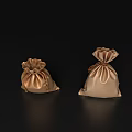 Elegant Decorative Ornament Set With Two Golden Satin Drawstring Pouches On Black Reflective Backdrop