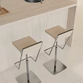 Modern Bar Stools With Beige Seats And Metal Frames Next To Light Colored Bar Counter