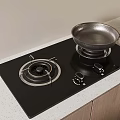 Black Gas Stove Top With Silver Frying Pan And Wooden Cabinets Against Light Colored Wall