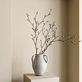 Minimalist White Ceramic Vase with Two Handles Holding Branches and Buds Against Light Colored Wall