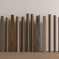 Various Colored Wooden Columns Arranged Against Light Wall On Wooden Floor