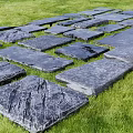 Road Facility With Irregular Gray Stone Slabs Walking Path On Green Grass