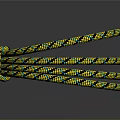 Yellow And Black Patterned Braided Rope Coiled On Reflective Surface