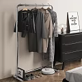Clothes Rack with Hanging Coats Black Dresser Lamp and Sign in Modern Room Interior