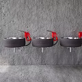 Three Black Tire Repurposed Washbasins With Red Faucets And Metal Brackets On Gray Textured Wall