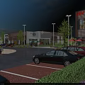 Modern Commercial Street With Parking Lot Cars Shops Buildings Greenery And Blue Sky