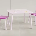 Pink Kids Table With Cartoon Patterns And Matching Pink Chairs With Princess Designs On Backs