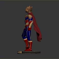 Man in Superhero Costume with Red Cape Blue Bodysuit and Golden Accents Standing on Base